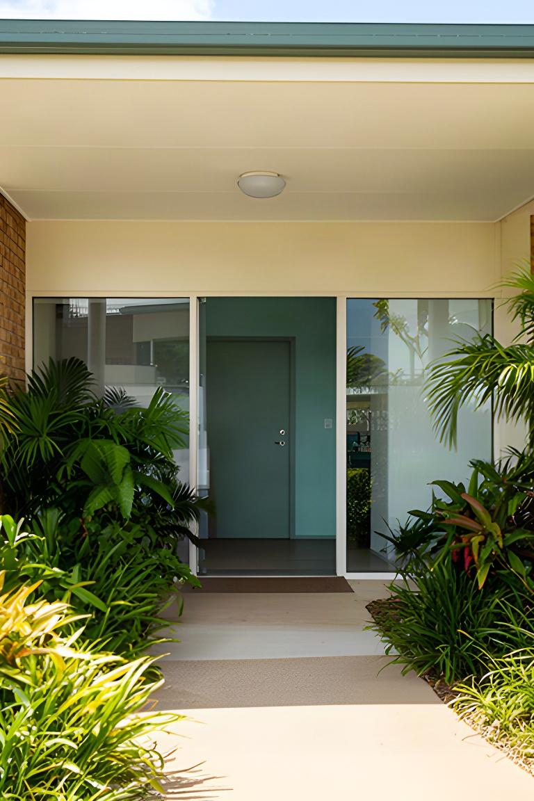 Exterior of the Marina Parade office in Ingham with a shaded entrance and Queensland tropical planting